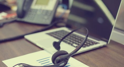 telephone headset, telephone and computer on a desk