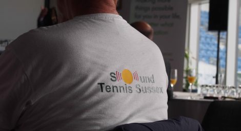 Member at launch event wearing sound tennis t-shirt