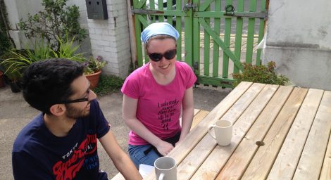 Two young people outside at a table