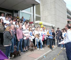 People gathered on steps before sponsored walk
