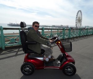 A person delivering a scooter in Brighton