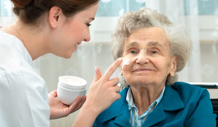 Photo of an older woman receiving a facial