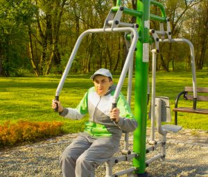 Photo of disabled man using outside gym