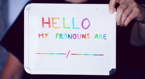 A whiteboard with colourful writing saying 'hello my pronouns are'